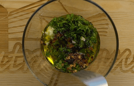 Stirring the Chimichurri sauce