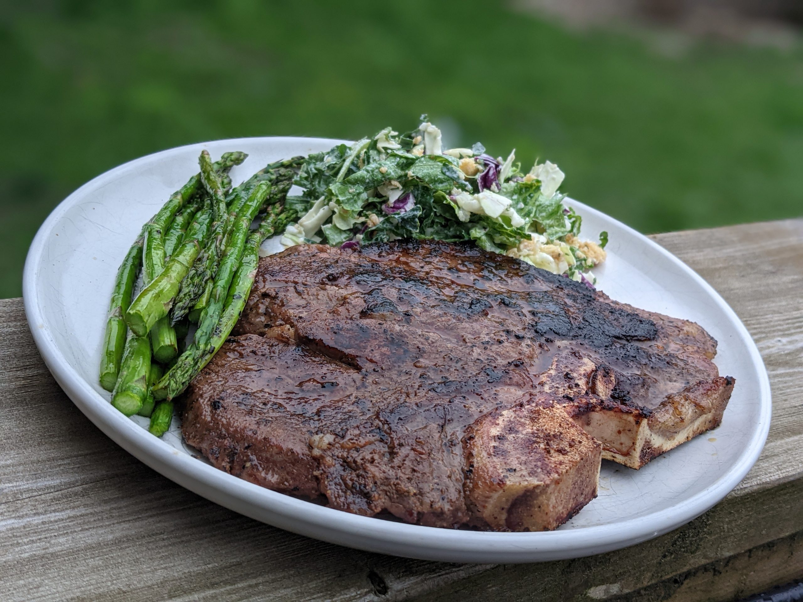 Classic-T-Bone-Steak-with-Grilled-Asparagus-and-Creamy-Kale-Caesar-Salad-Nutrafarms-Grass-Fed-Steak-Image-3