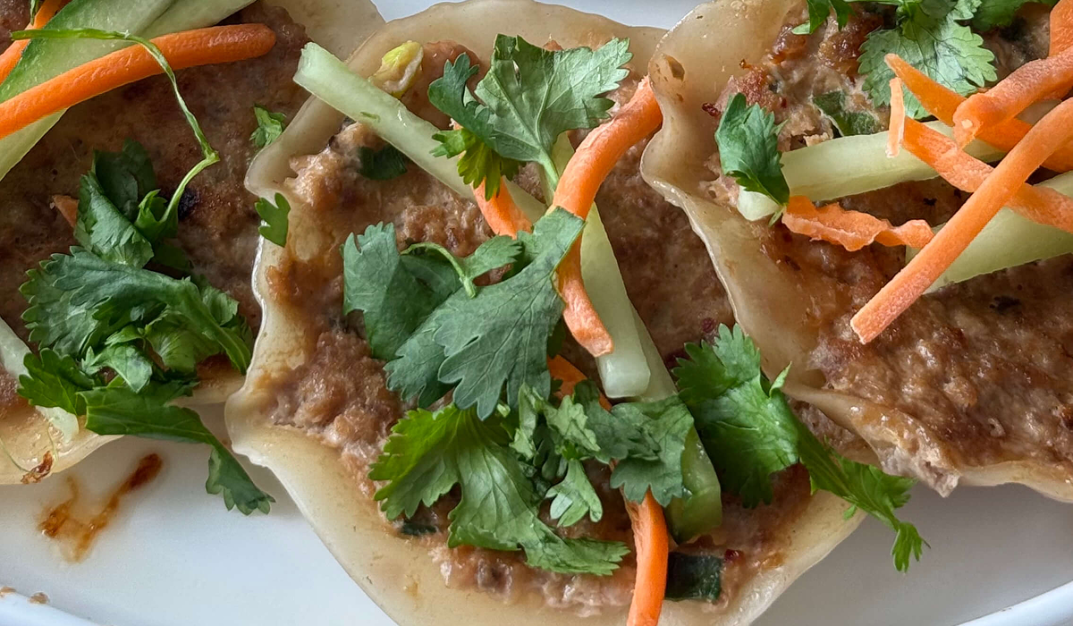 Crispy wonton chicken tacos topped with carrots cucumber and cilantro Crispy wonton chicken tacos topped with carrots cucumber and cilantro