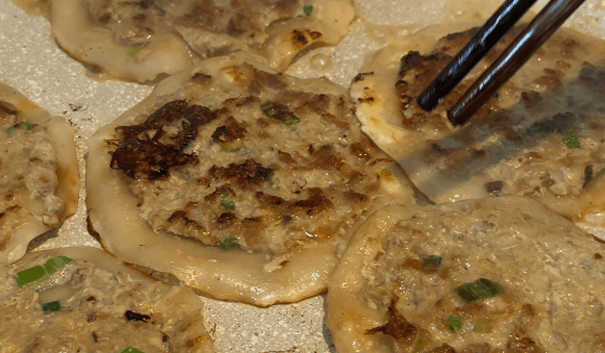 Wonton chicken tacos frying in a pan until crispy and golden brown Wonton chicken tacos frying in a pan until crispy and golden brown